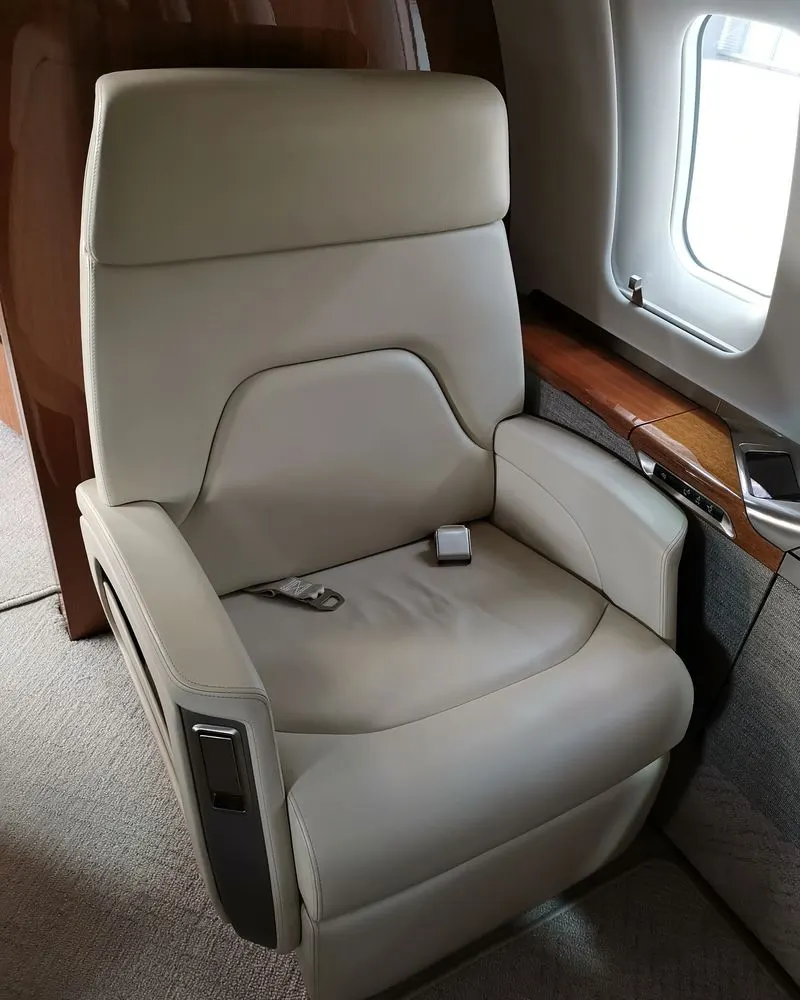 Single cream leather executive seat with wood trim after interior detailing
