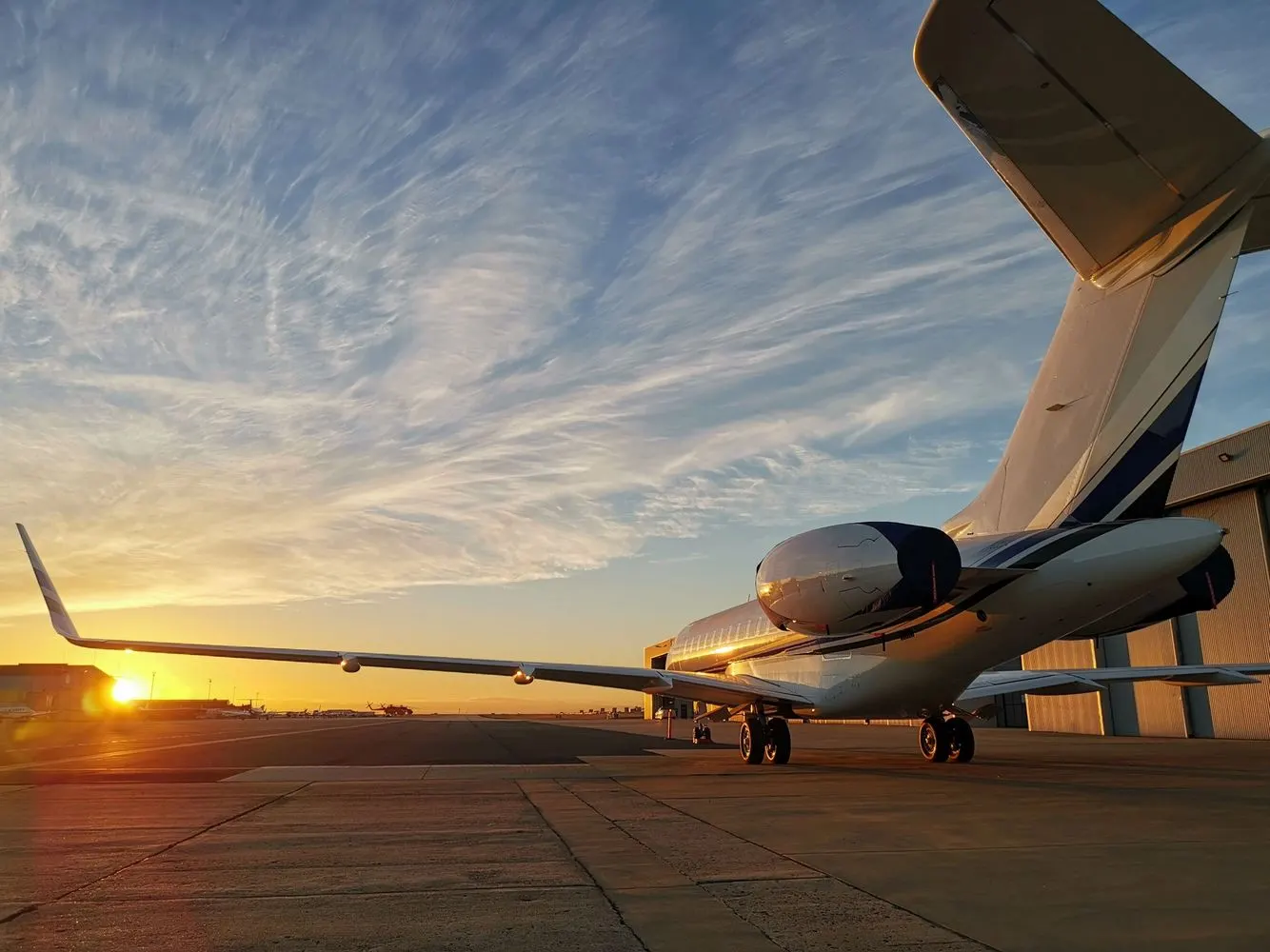 Large-cabin jet wing and winglet against a sunrise sky after exterior detailing