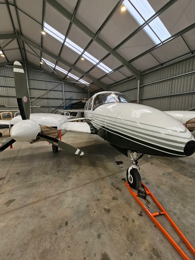 Twin piston aircraft inside a hangar after exterior detailing
